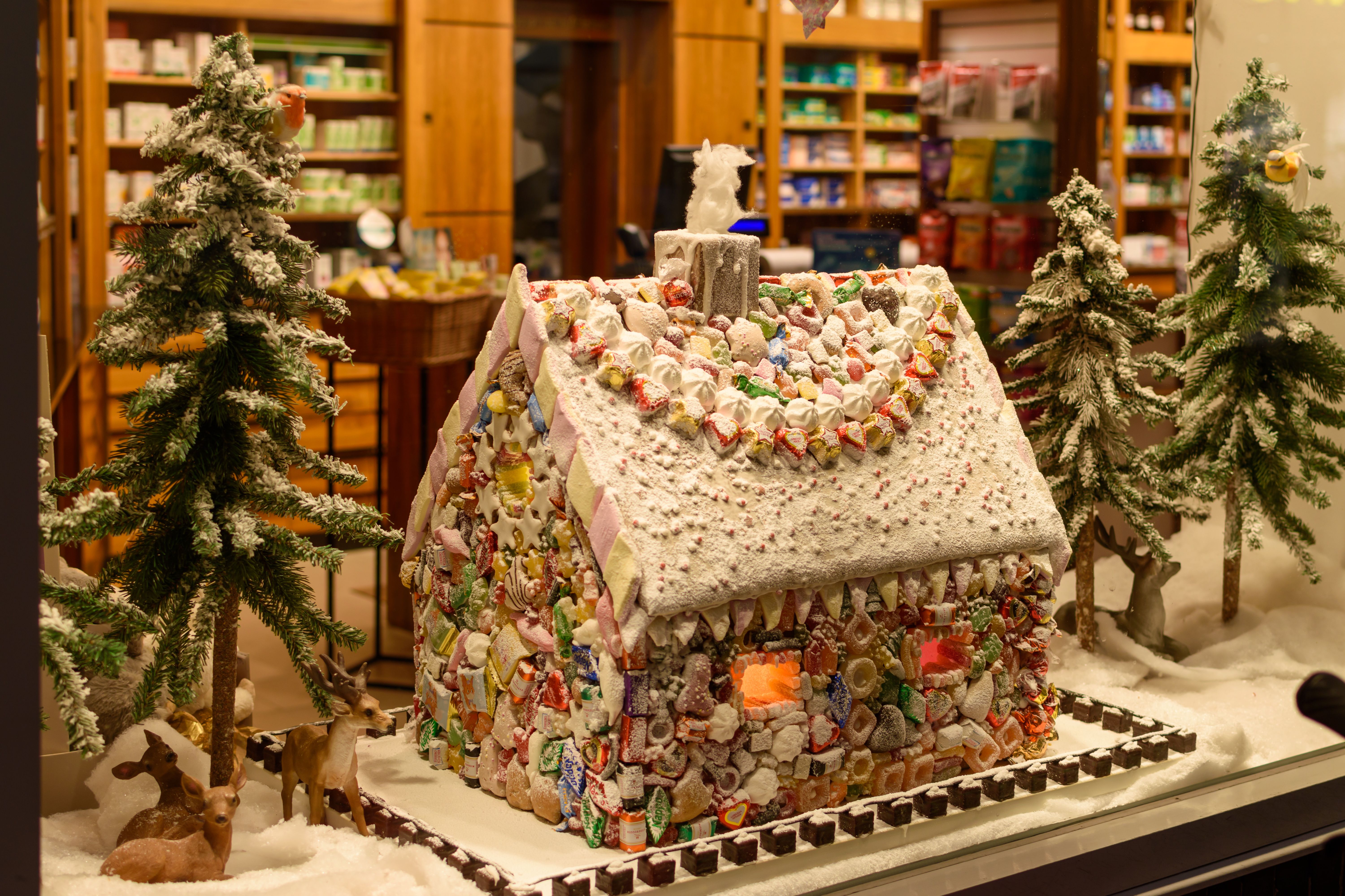 Festive Gingerbread House Display in Storefront · Free Stock Photo