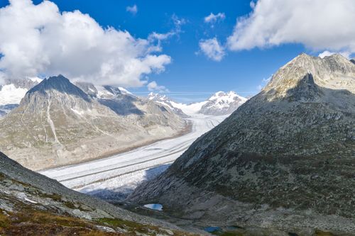 Free Stunning view of Aletsch Glacier surrounded by Swiss Alps under a clear blue sky. Stock Photo