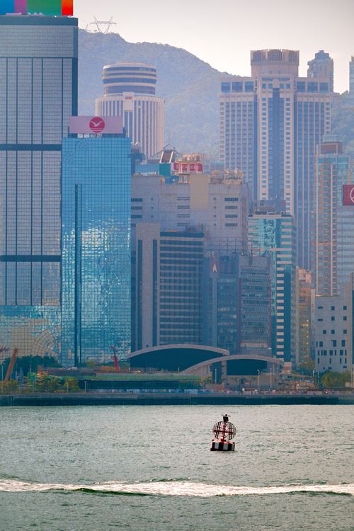 Free Vibrant view of Hong Kong's skyline with a buoy in Victoria Harbour. Stock Photo