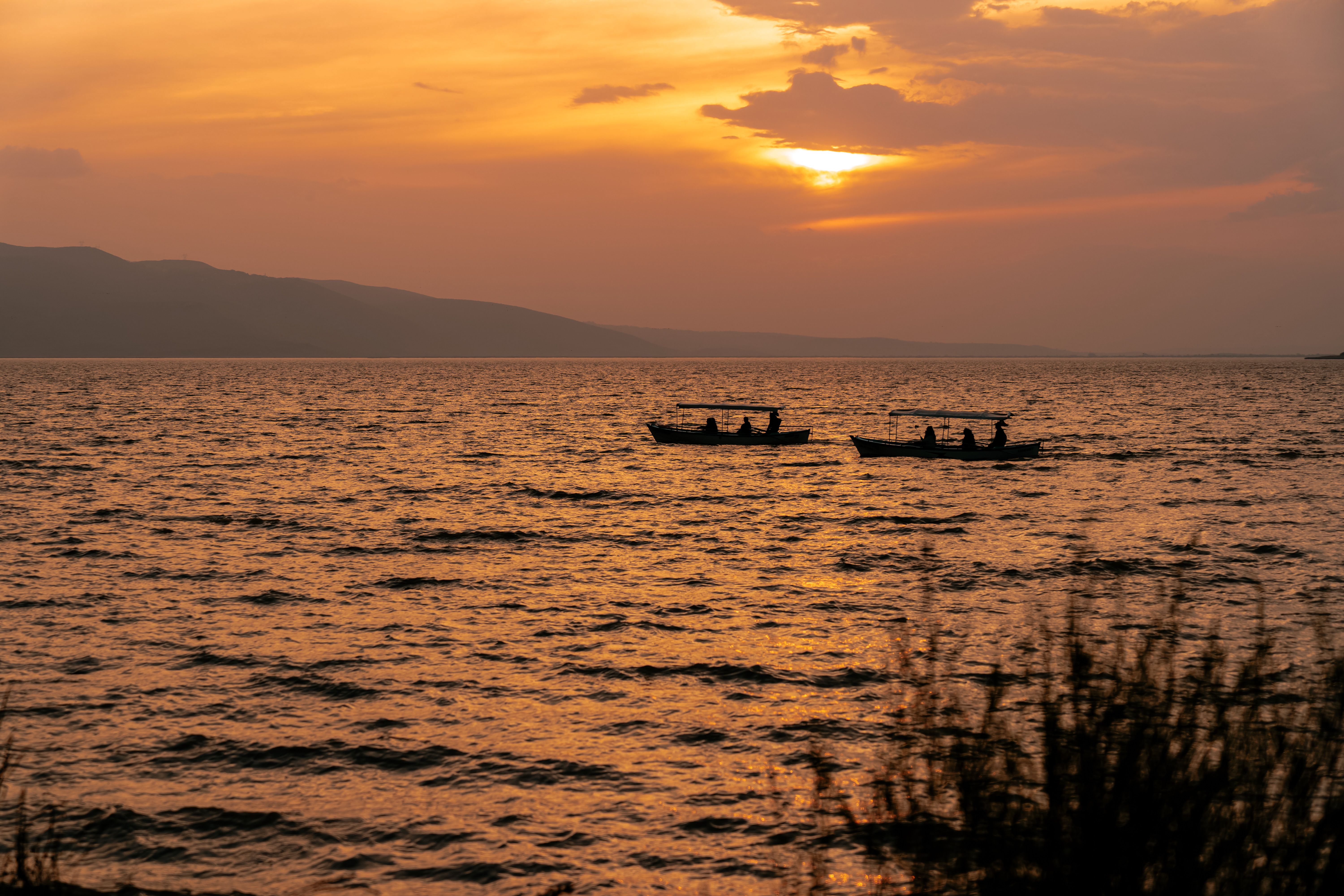 Dramatic sunset over lake ulubat with boats, Burundi