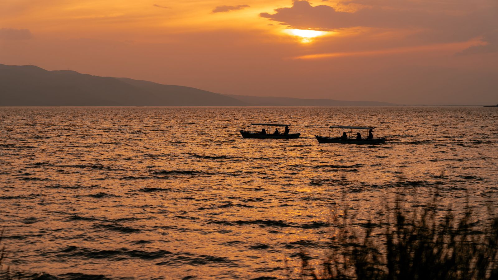 Dramatic sunset over lake ulubat with boats, Burundi