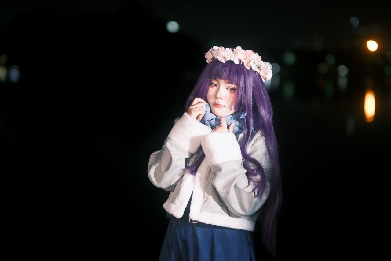 a captivating cosplay portrait with a woman in a purple wig and floral