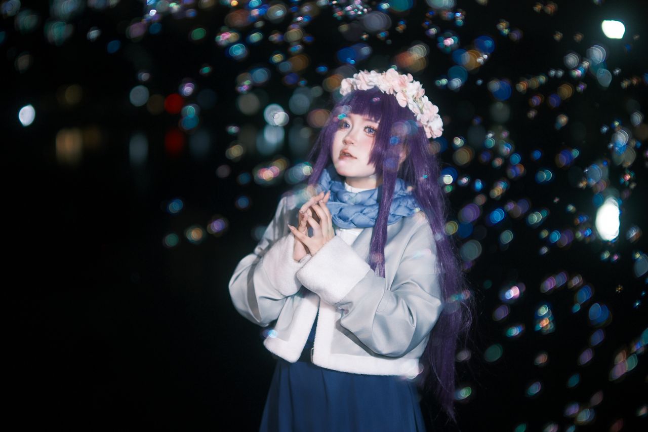 magical night time portrait of a woman in floral headpiece with bokeh