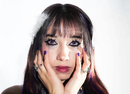 Free Stunning close-up portrait with purple makeup and glitter, showcasing creativity and vibrant fashion. Stock Photo