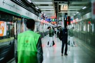 People waiting at a subway platform in Nanjing, China, showcasing urban commute.
