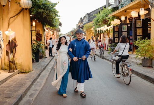 A couple in traditional Vietnamese clothing strolls through the charming streets of Hội An.