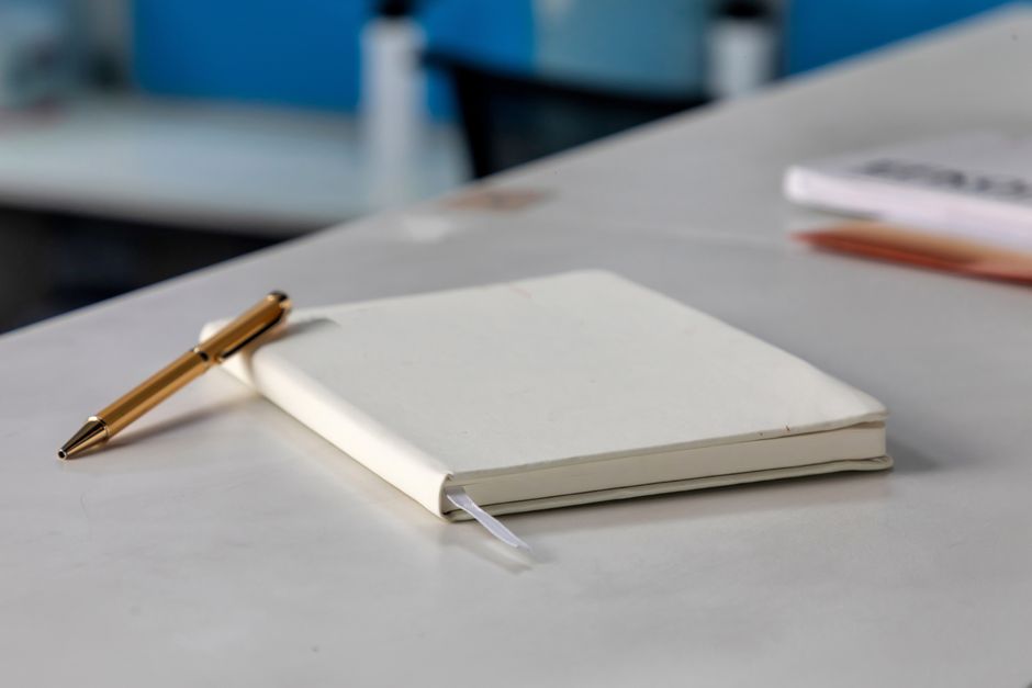 notebook and pen on desk candid lifestyle lifestyle photo 2