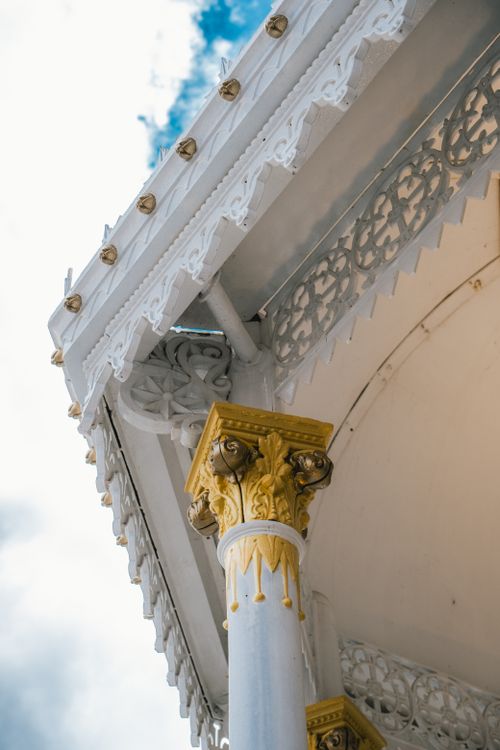 Free Detailed view of a decorative column with intricate patterns set against a bright sky. Stock Photo