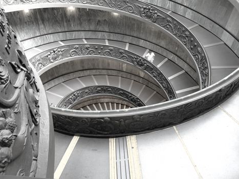 Elegant spiral staircase with decorative motifs in a modern architectural setting.