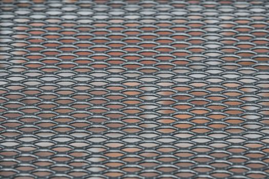 Detailed view of a metal grid pattern with a textured surface, ideal for industrial design themes.