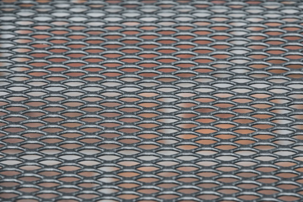 detailed view of a metal grid pattern with a textured surface ideal fo