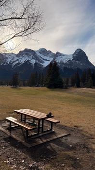 A serene picnic area with stunning snow-covered mountains in the background.
