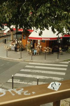 Discover a quaint Parisian brasserie captured in a quiet corner of Île-de-France. Perfect for lifestyle and travel themes.