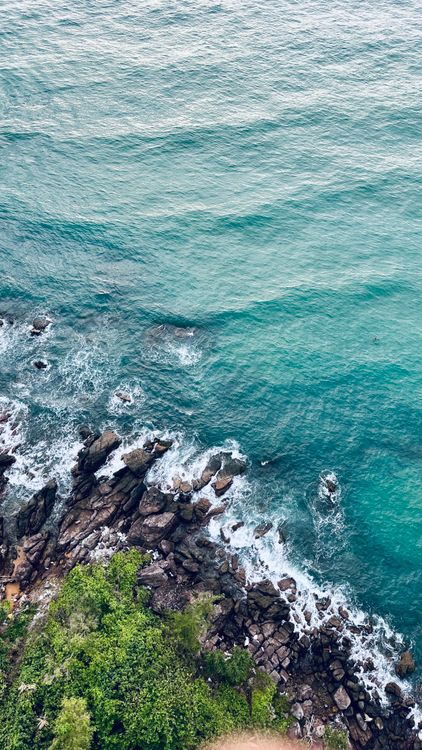 Aerial View of Rocky Coastline and Turquoise Sea · Free Stock Photo