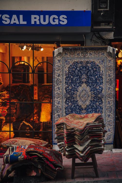 Free A charming display of vibrant rugs outside a carpet store in İstanbul, offering a glimpse of local culture. Stock Photo