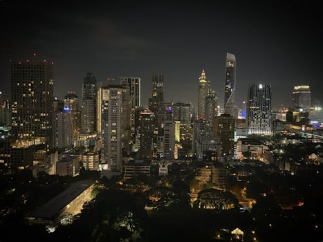 Stunning night view of Bangkok's skyline with lit skyscrapers, showcasing the city's urban vibrance.