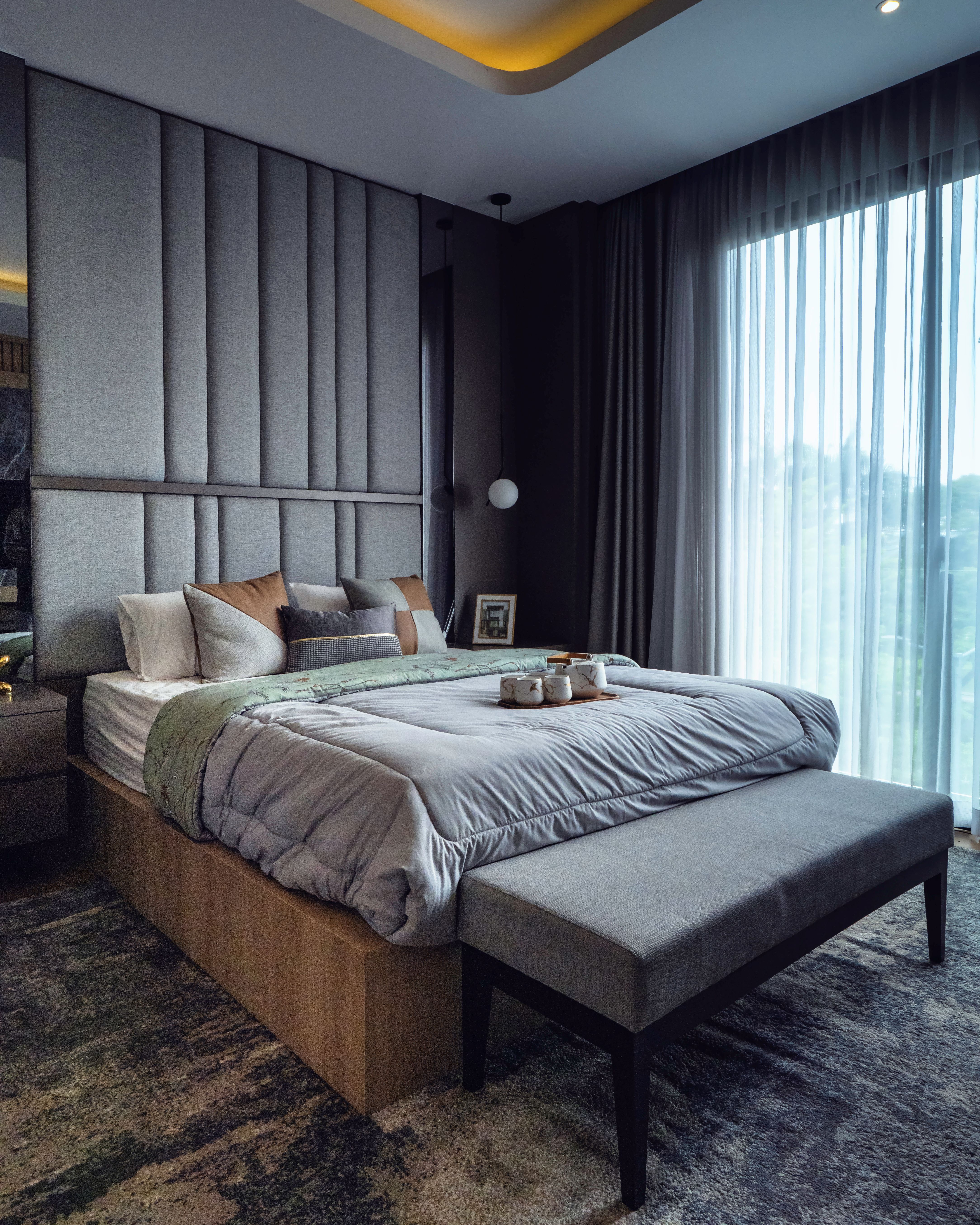 Warm lighting in dark grey bedroom