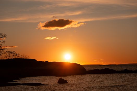 Capture the serene beauty of a fall sunrise over Cove Island Park in Stamford, Connecticut.