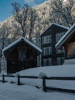 Stunning snowy scene featuring traditional cabins in Glarus, Switzerland amidst a serene winter landscape.