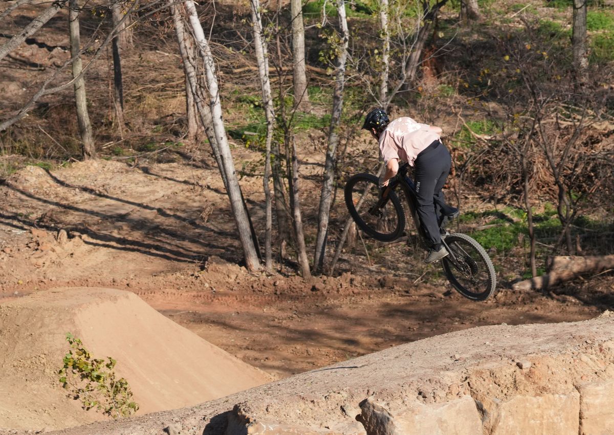 Kid in helmet on dirt jumps