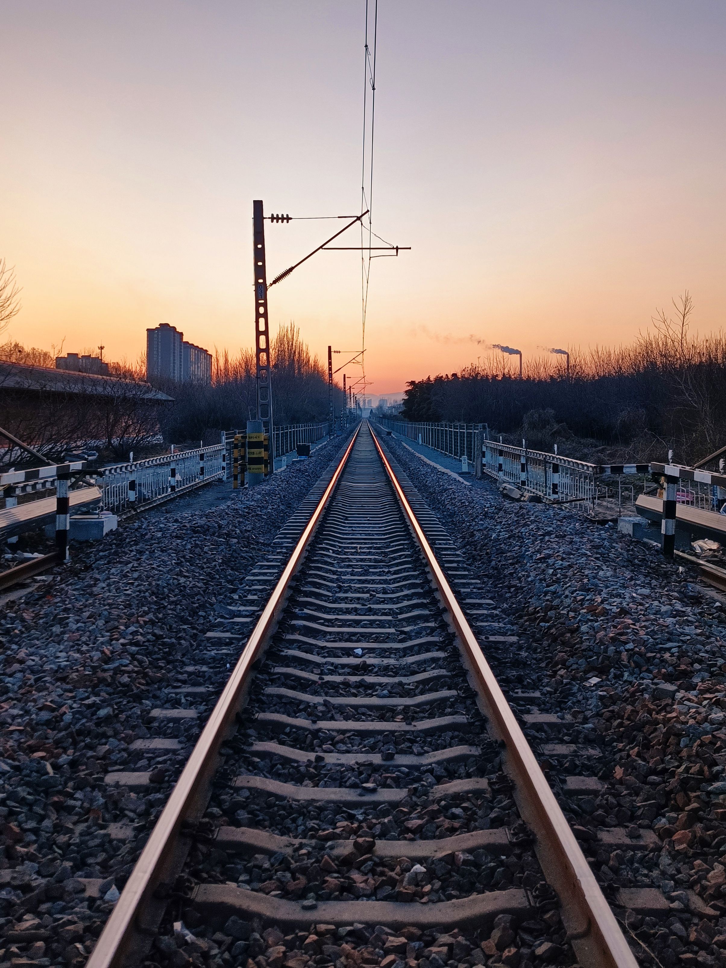 Sunset View of Railway Tracks in Urban Landscape · Free Stock Photo