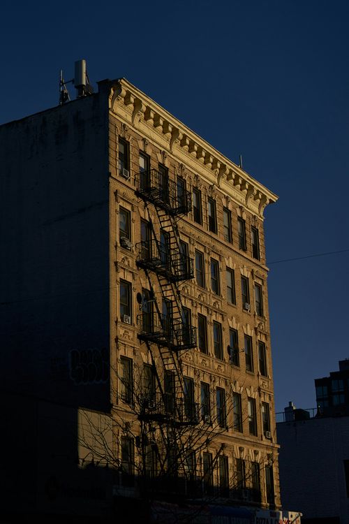 Free Old New York City building with fire escape against a twilight sky. Stock Photo