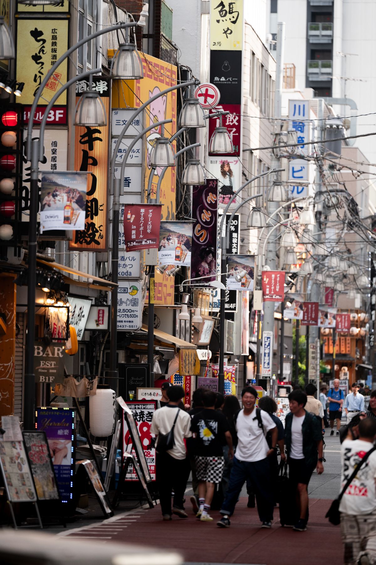 Busy Japanese shopping street lined with shops and signs