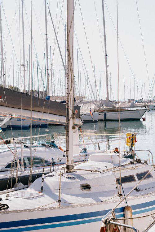 Free Peaceful marina with sailboats basking under a bright sunlit sky. Stock Photo