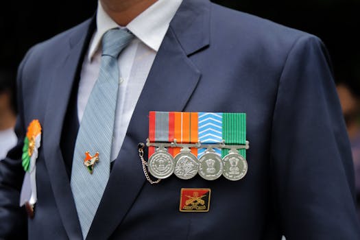 Close-up of an Indian military ceremonial uniform with medals and Indian flag pin