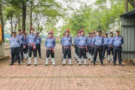 Group of uniformed men at attention outdoors
