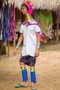 Woman With Gold Chain on Neck Standing Near Hut