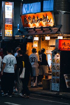 Crowded ramen shop at night in Tokyo, Japan, capturing local street life.