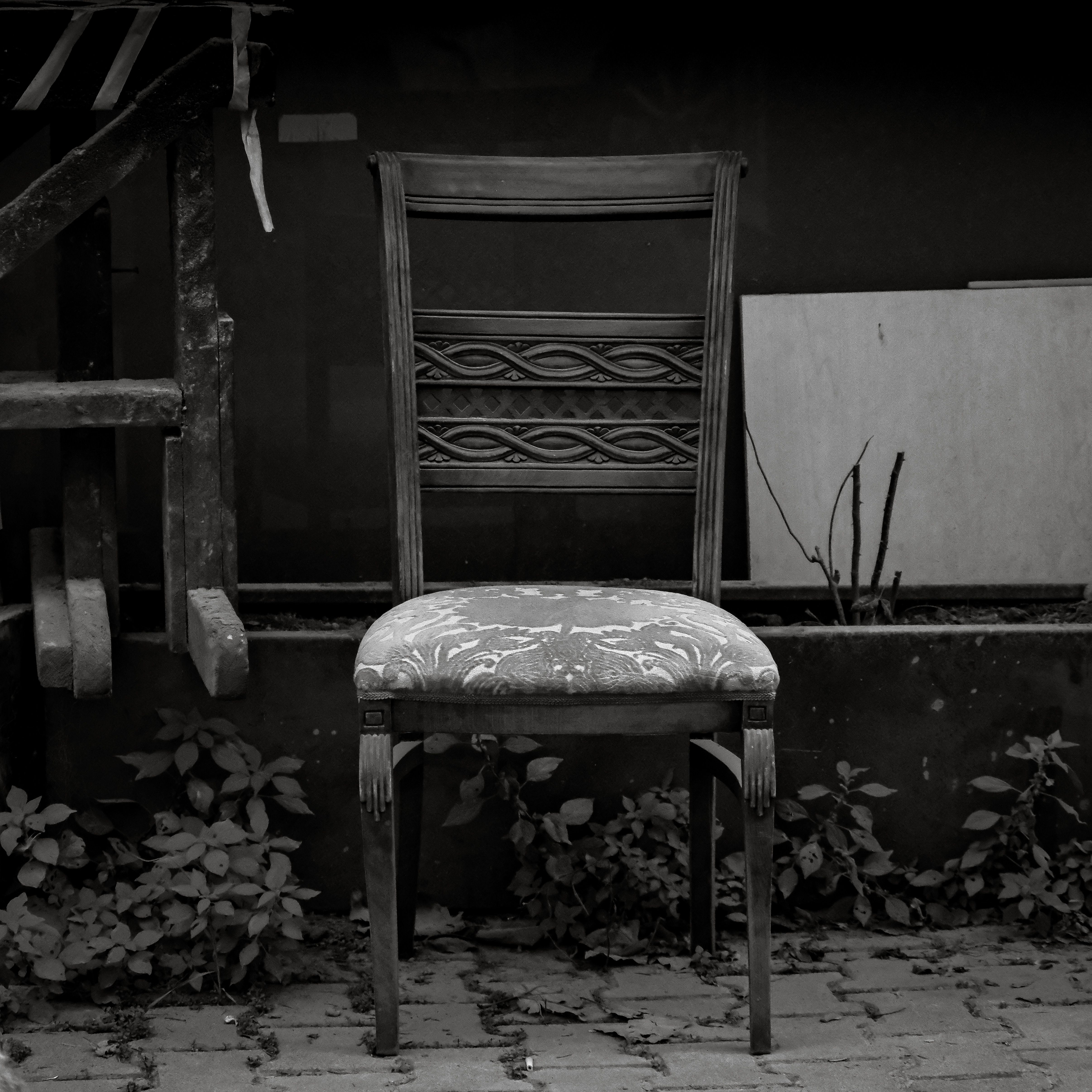 Elegant black and white photo of a vintage wooden chair on an Istanbul street.