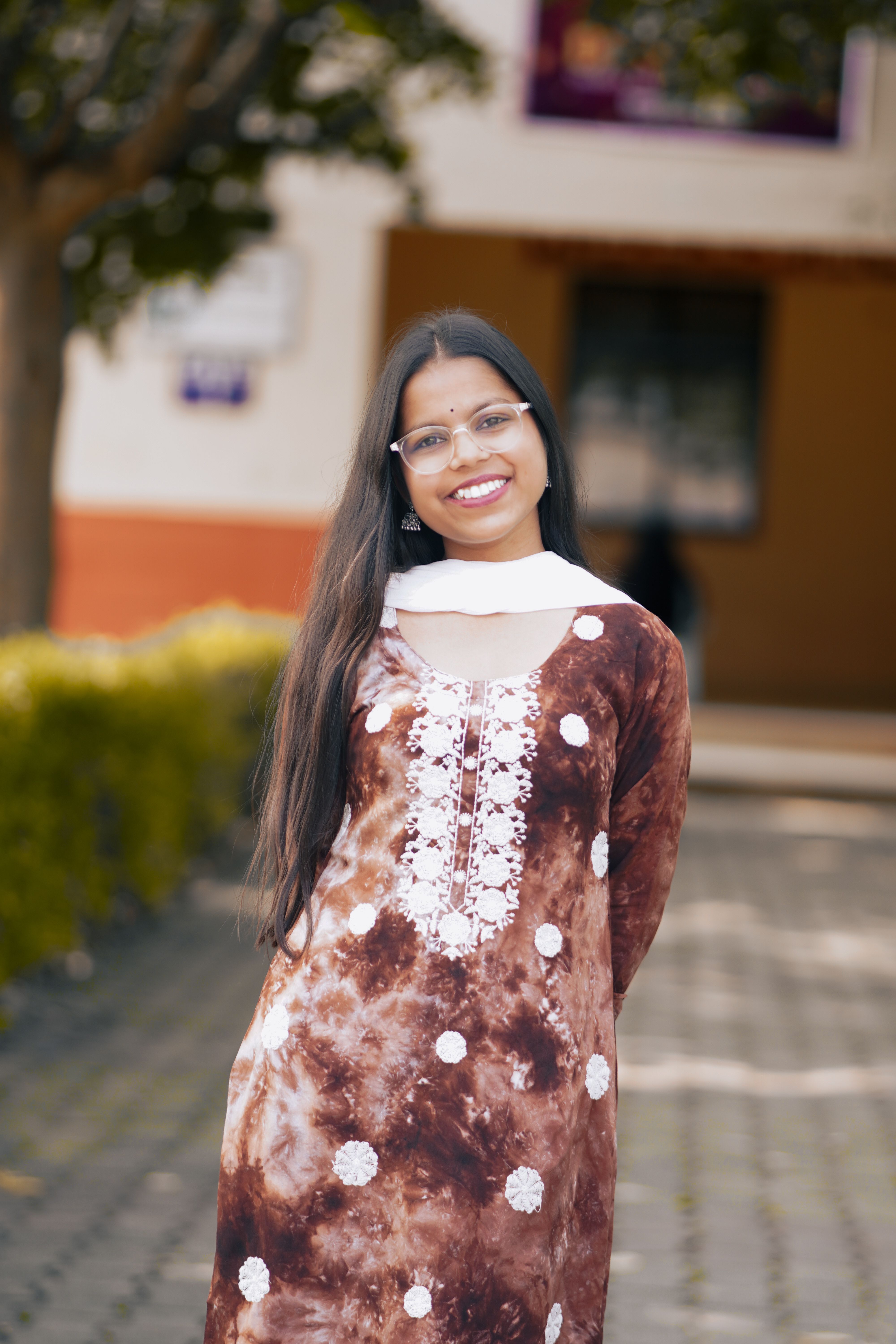 Smiling Woman in Traditional Dress Outdoors · Free Stock Photo