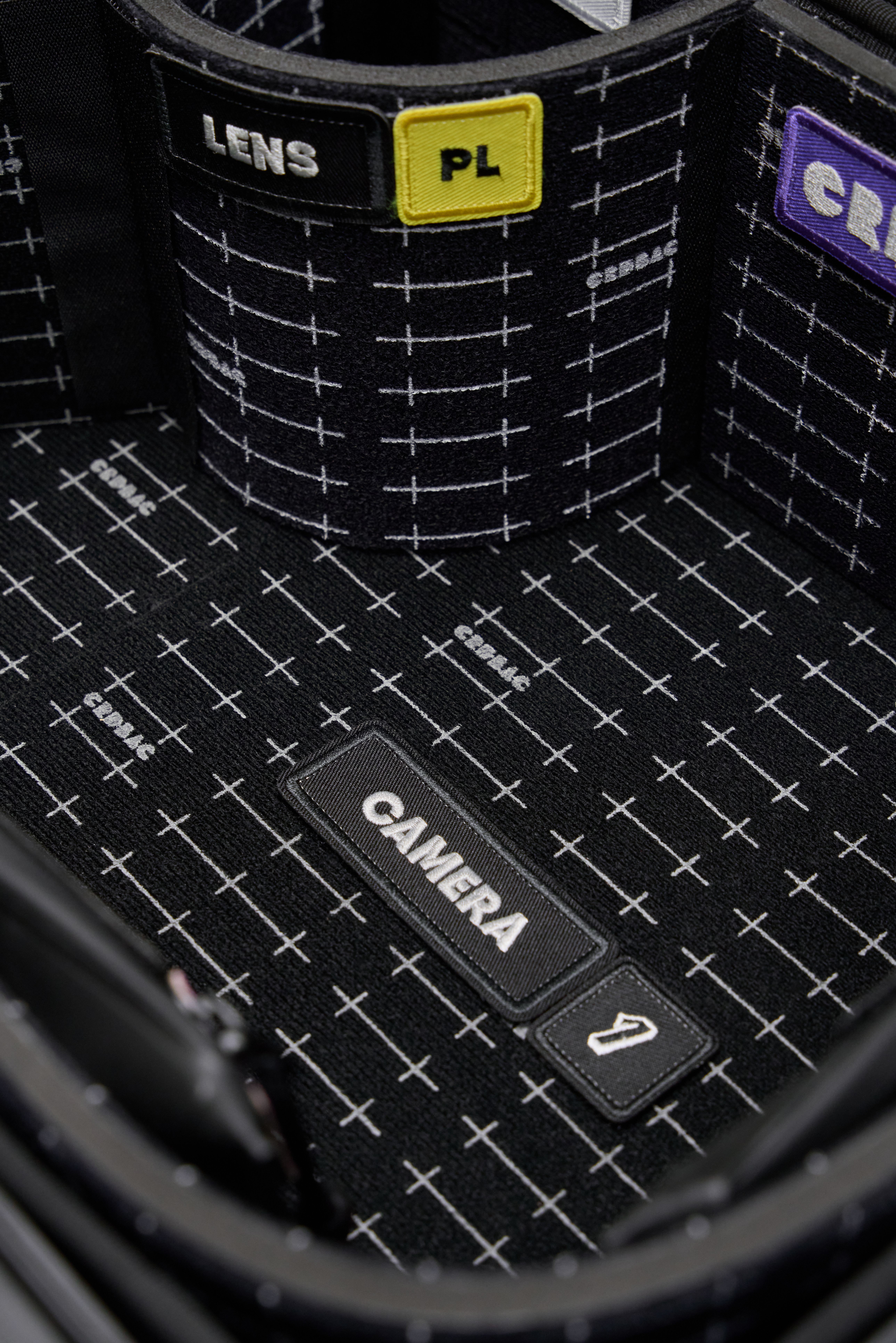 Detailed view of a crdbag's compartmentalized interior for camera and lens storage.