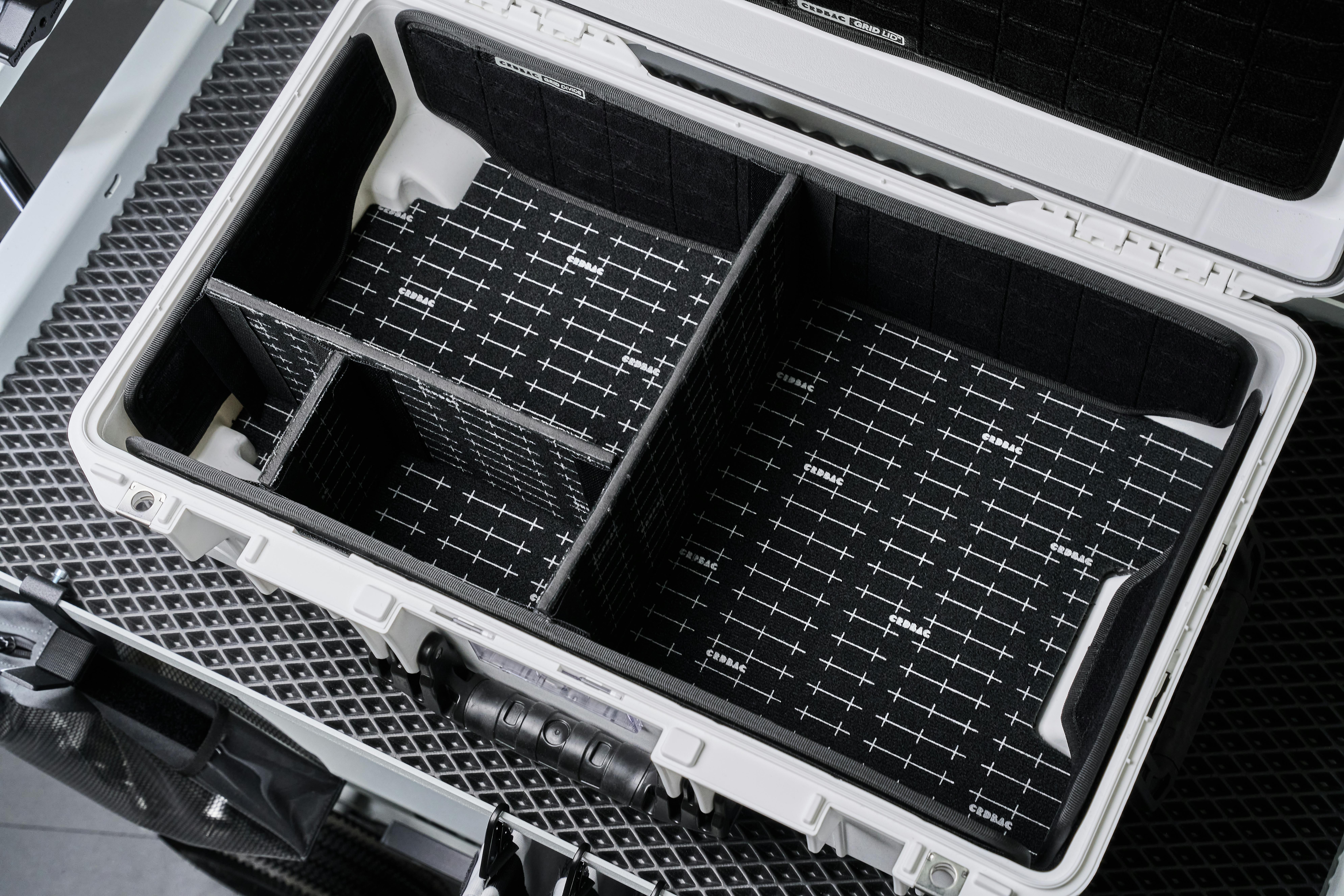 Top view of an open hardcase with customizable compartments for organizing camera equipment.