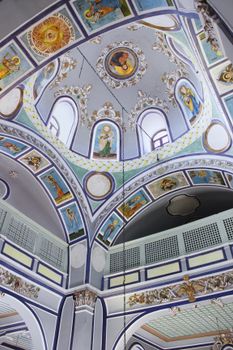 Stunning view of an Orthodox church interior with colorful frescoes.