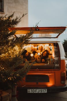 A warm holiday moment inside a festively decorated vintage van at dusk.