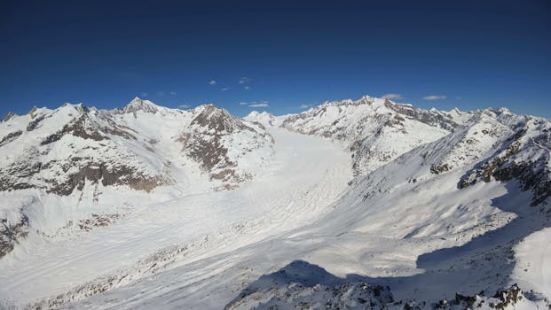 Stunning aerial shot of the snow-capped Alps in Fieschertal, Switzerland, showcasing breathtaking mountainous landscapes.