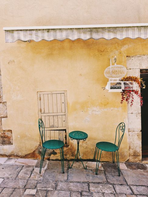 Idyllic outdoor café setting with vintage green chairs in Valbonne, Provence.