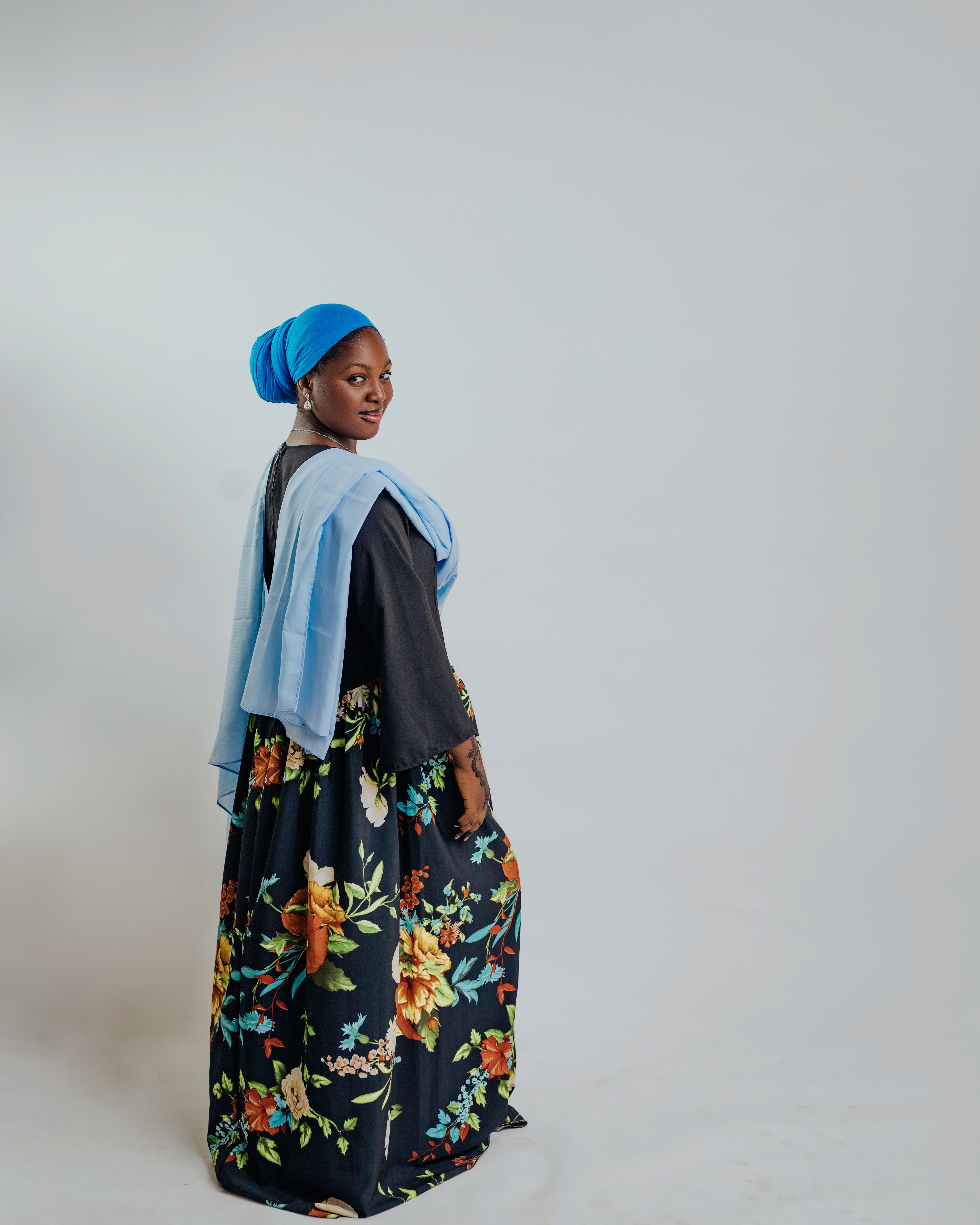 Elegant Woman in Floral Dress with Blue Headscarf · Free Stock Photo
