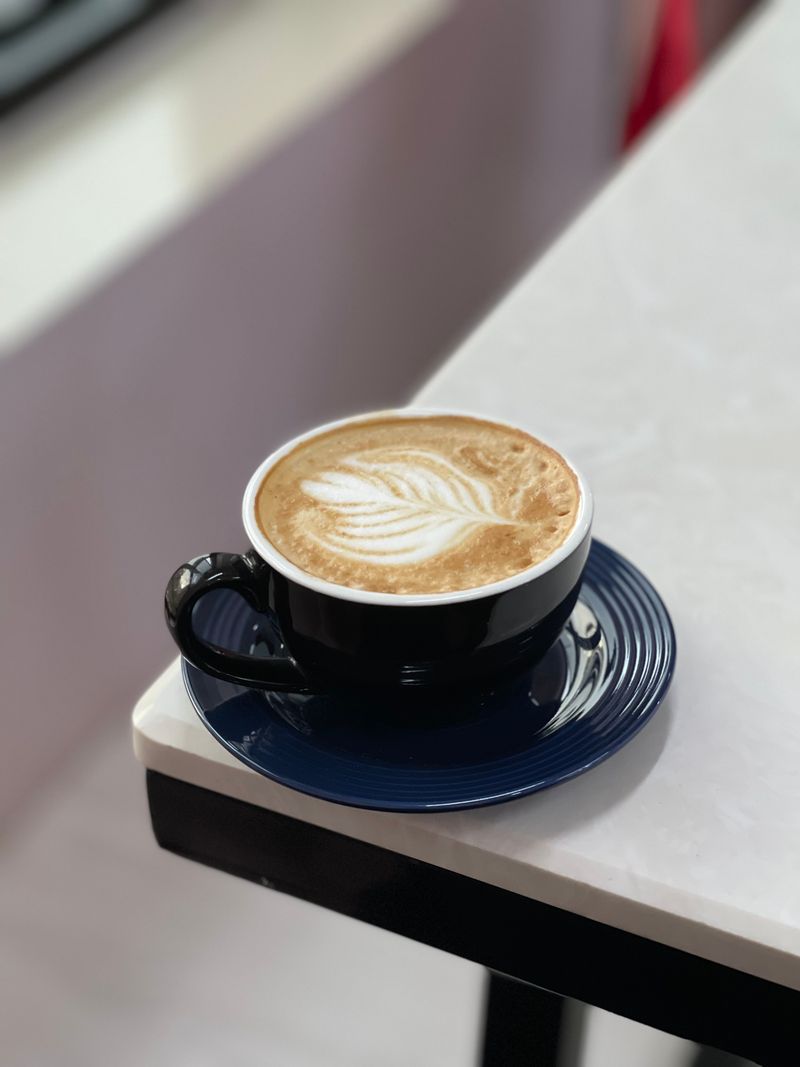 Fern-like latte art design, an example rosetta-style pour, for illustration