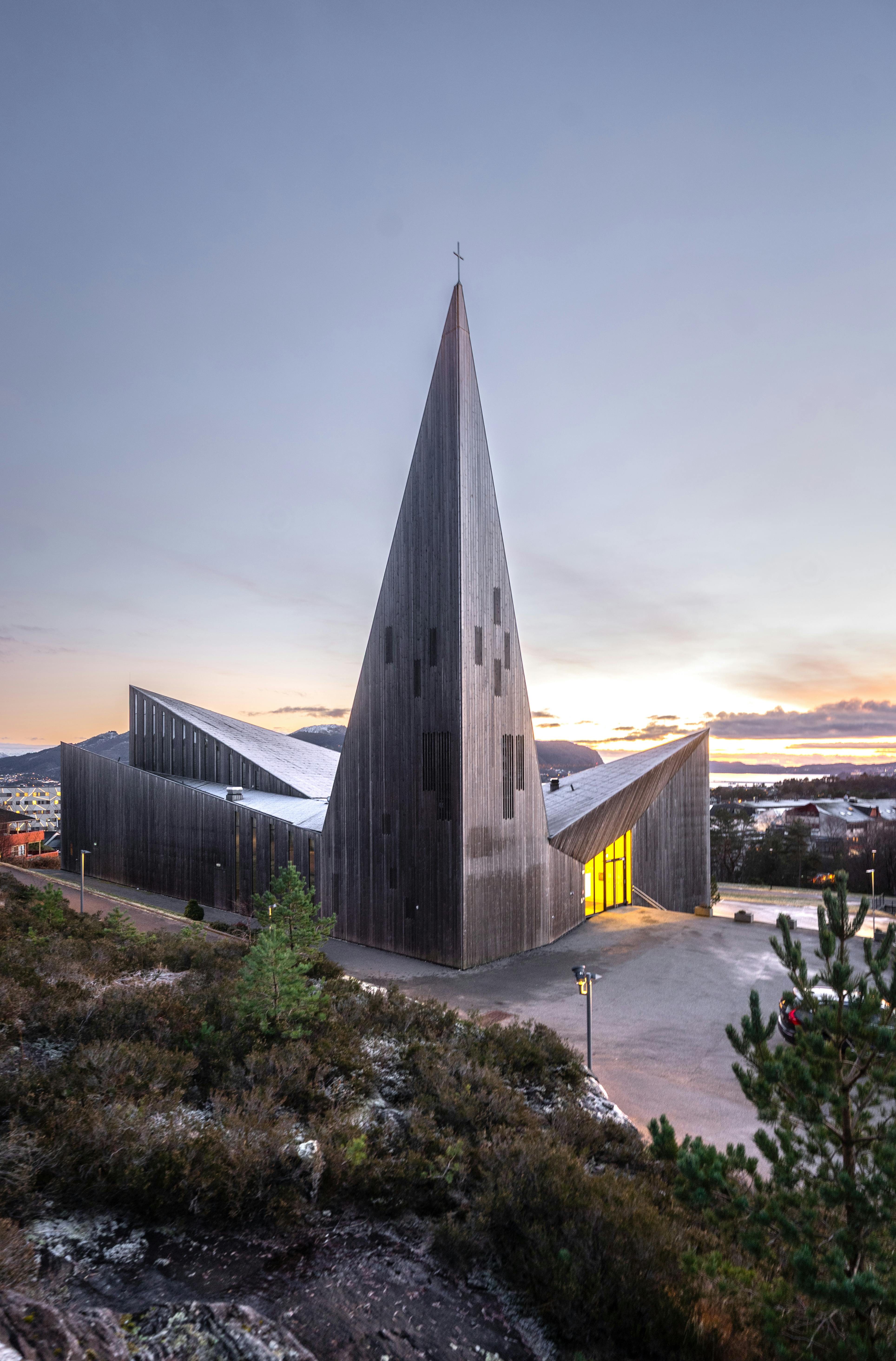 Striking architecture of the Arctic Cathedral in Tromsø during a serene sunrise.