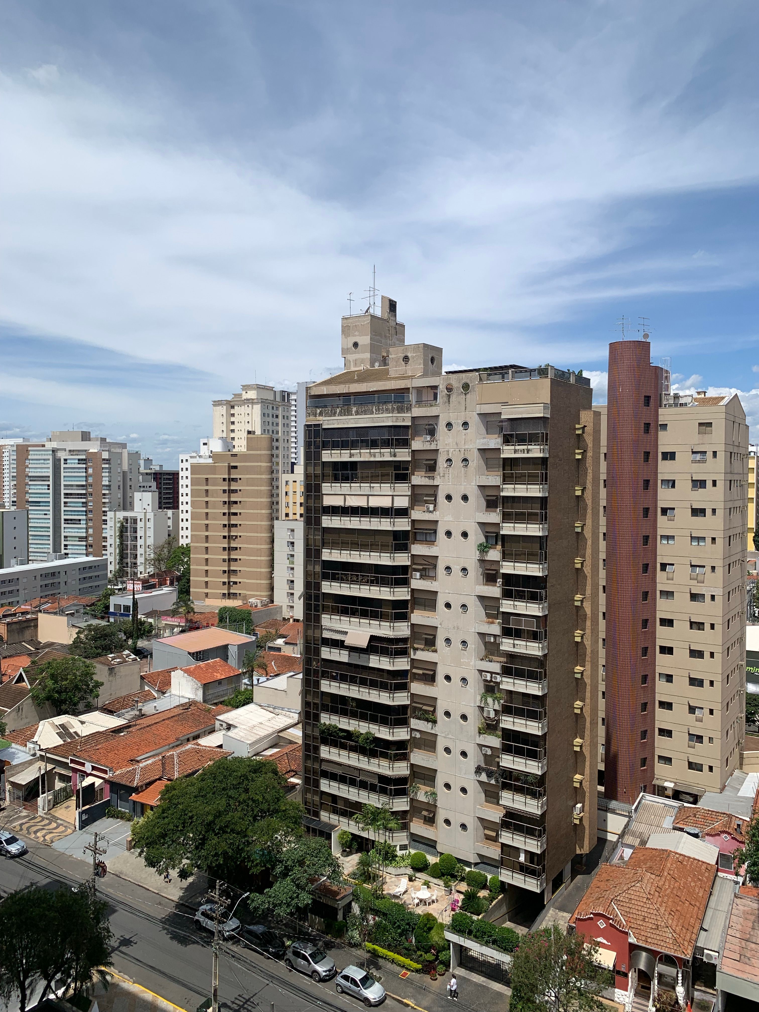 Scenic cityscape featuring diverse high-rise buildings under a vibrant sky.