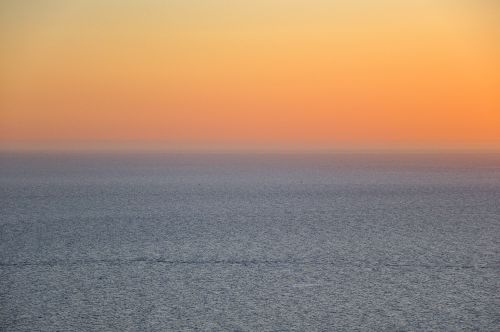 Free A breathtaking sunset over the ocean from Montevideo, Uruguay, showcasing vivid orange and blue hues. Stock Photo