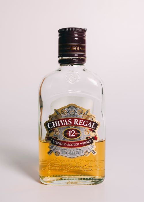 Free Close-up of a Chivas Regal 12 year aged blended Scotch whisky bottle against a plain background. Stock Photo