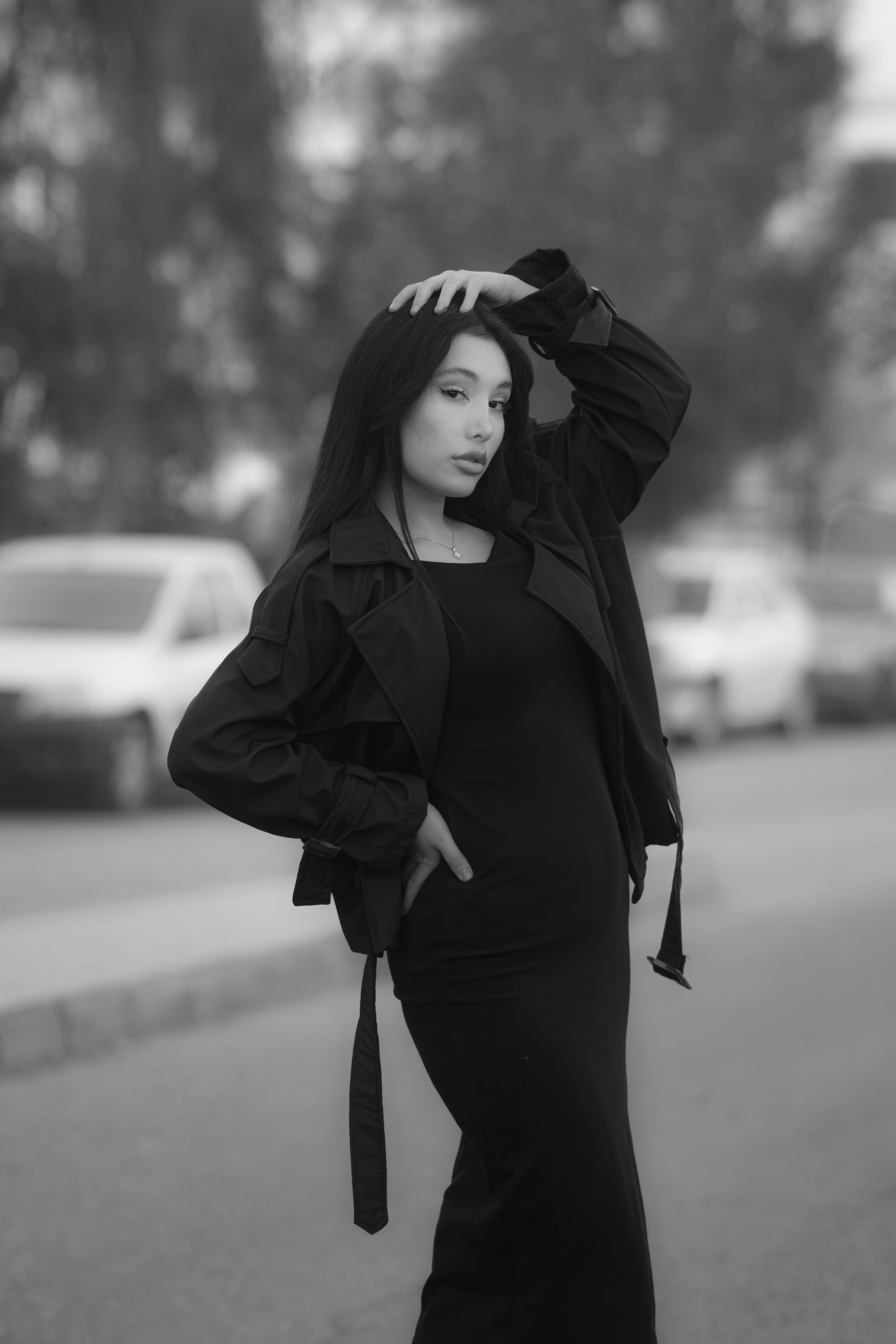 Stylish black and white photo of a woman posing in an outdoor setting in Tehran.