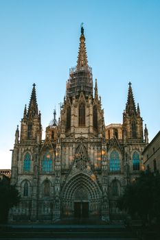 The majestic Barcelona Cathedral showcases stunning Gothic architecture under a clear blue sky.
