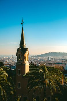 A picturesque shot of Park Güell with sweeping views of Barcelona cityscape at dawn.