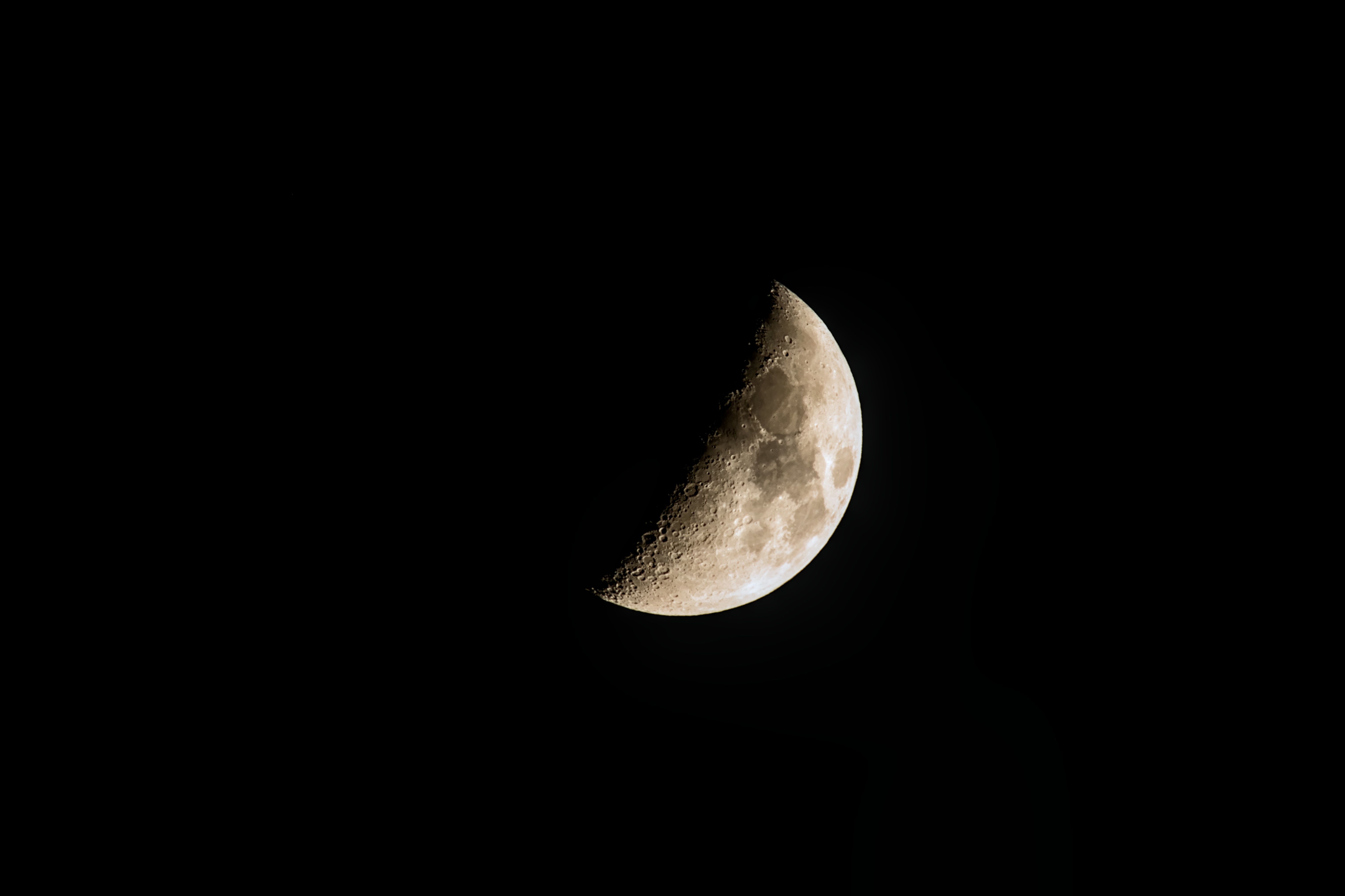 Captivating crescent moon in the clear night sky over Płock, Poland.